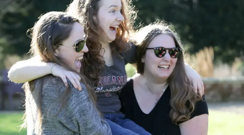 Group of three teenage girls laughing