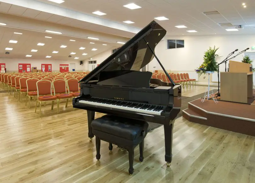Large conference hall with stage and grand piano