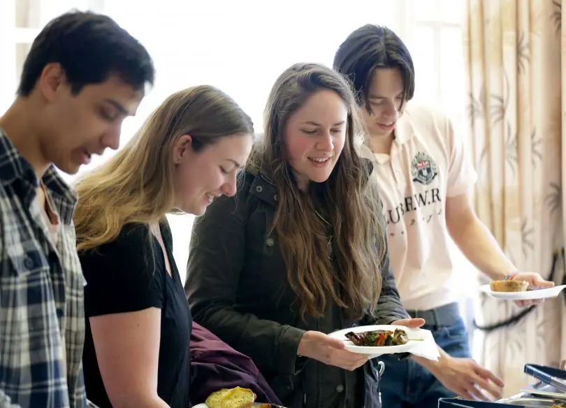 Youth group choosing food in dining room