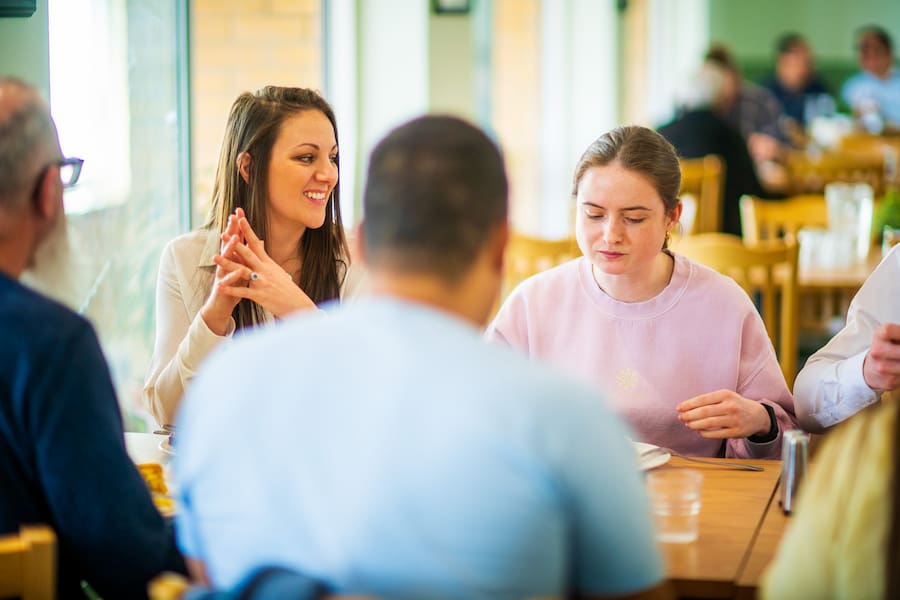 A group eating at a table in one of our dining rooms at The Hayes centre.