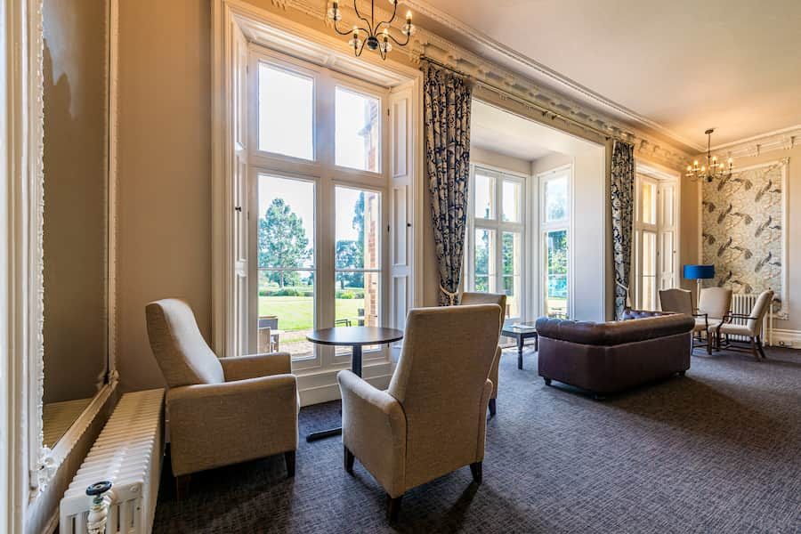 A image of the Drawing Room letting lots of light in with a good view of High Leigh's grounds.