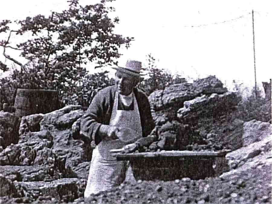 James Pulham working on his Pulhamite landscaping with a tool in his hand at a workbench