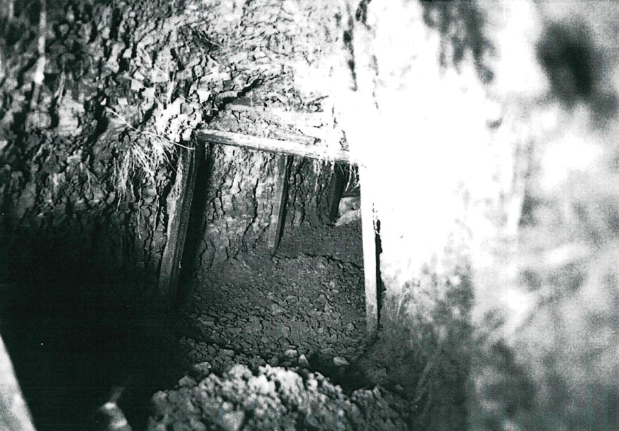 A black and white image of the tunnel held up by the wooden supports of old chairs.