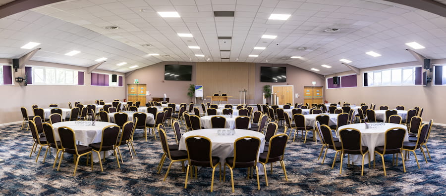 The Derbyshire Hall set as banquet layout with the new grey and purple colour scheme and fresh new carpet bringing a brand-new clean aesthetic.