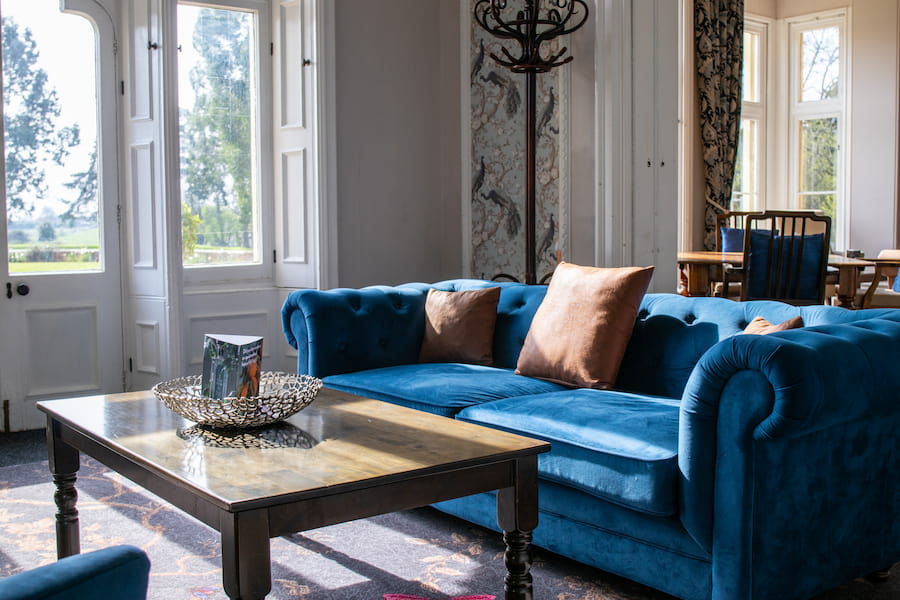 The end room of the Woodlands Lounge showing the blue sofa and new carpet.