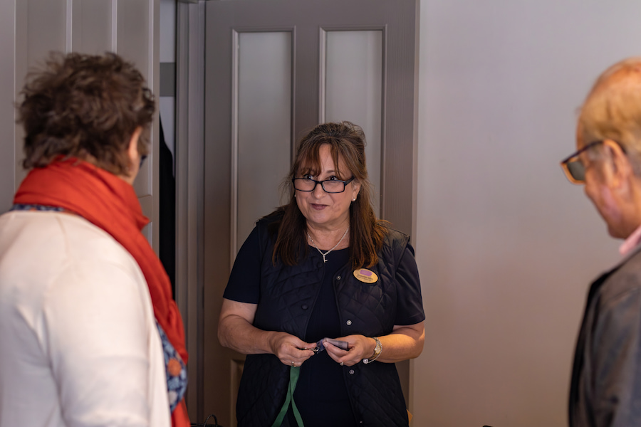 A front-of-house team member assisting a guest at Highgate House conference centre.