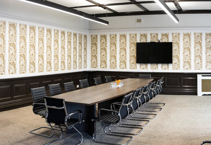 The Boardroom at The Hayes showing the long table and chairs and the TV.