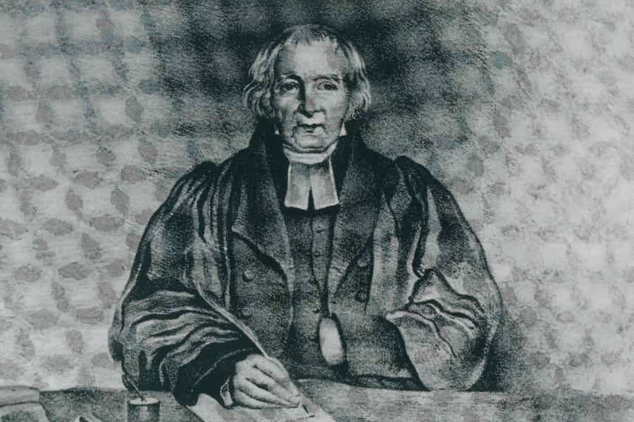 A painting of Reverend Thomas Jones at a table writing with a quill.