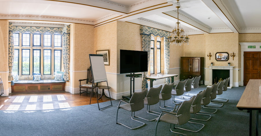 The Rowan room showing the boardroom table and chairs, historic furniture and beautiful views.