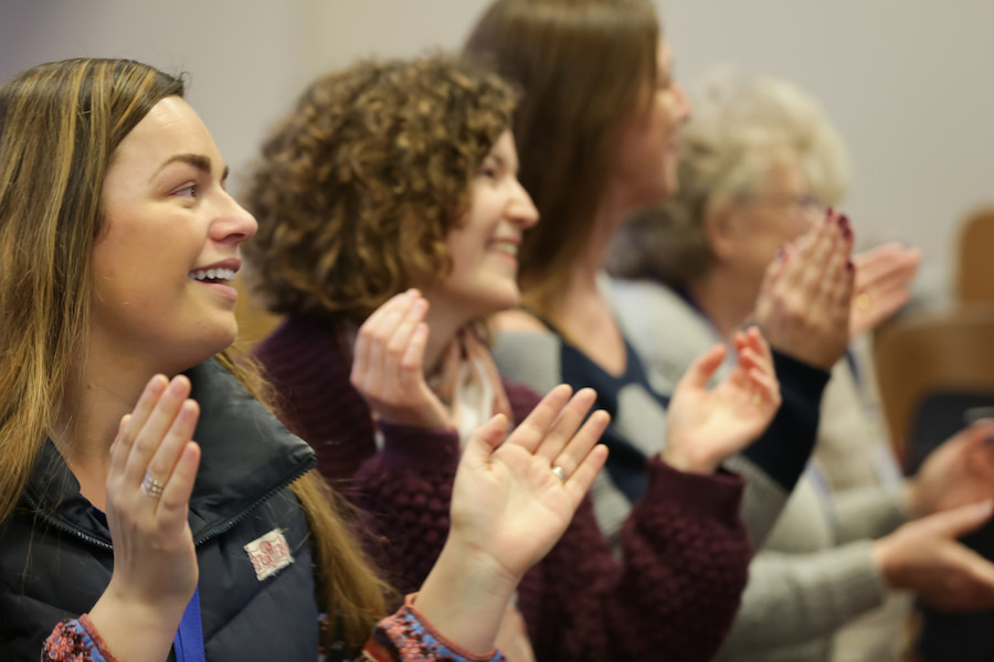 A group of women worshipping during a women's conference.