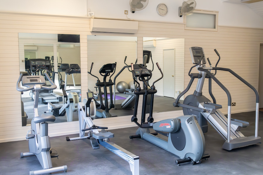 The gym from another angle again showing the stationary bike, row machine, elliptical and stair climber.