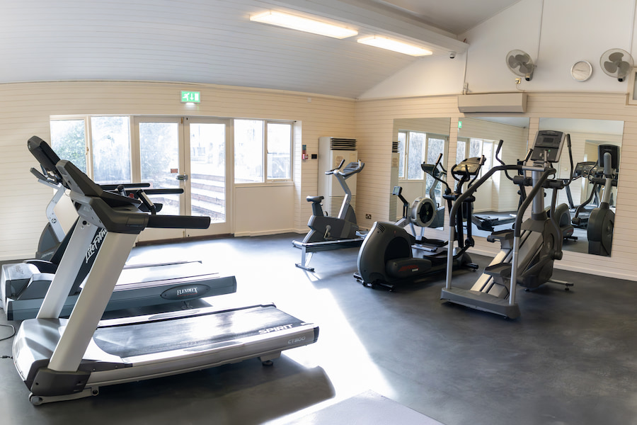 The Gym from a different angle showing the row machine, stationary bike, elliptical, and stair climber