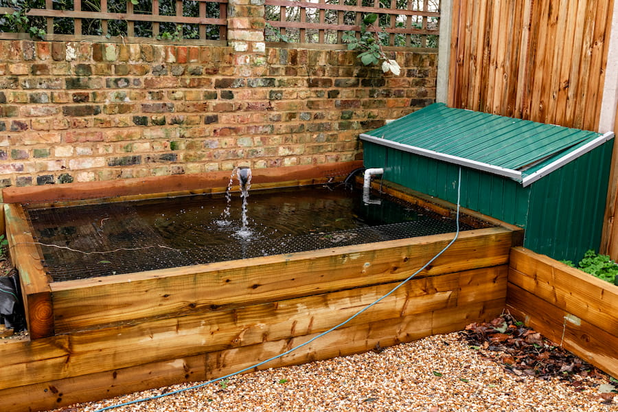 A fish pond with a little fountain at the back of the Market Garden