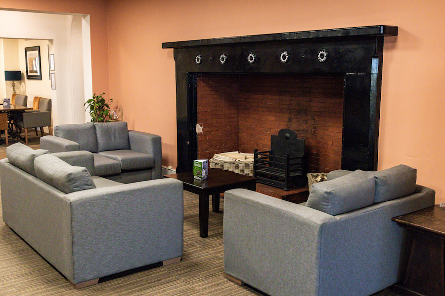 The fireplace after the refurbishments surrounded by comfortable seating.