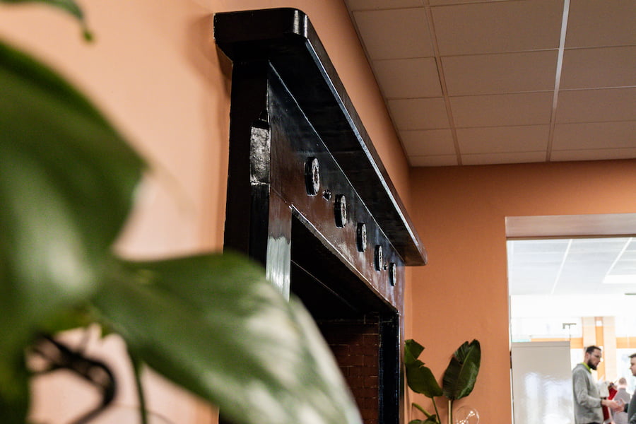 A close up of the woodwork on the fireplace.