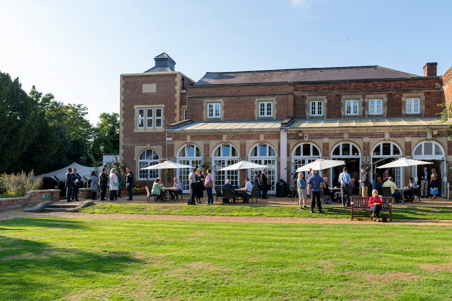 An image of people outside the Tower at High Leigh on a sunny Summer's evening.